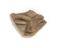 Fragment of clay vessel with figurative decoration. The decoration modelled in half relief shows a grotesque face with narrow slit eyes, raised eyebrows, a large, upward curled nose and a small mouth. A curled moustache was shown using incised lines.;