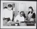 Photograph of Raghu Vira, Chang Shuhong and Sudarshana Devi Singhal studying newly discovered manuscripts at the Dunhuang Institute taken in 1955.