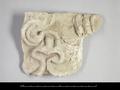 Fragment of a stucco figure, probably depicting drapery.