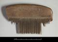 Fragmentary wooden comb with a slightly arched top. Some of the teeth have broken off.