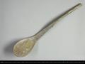 Flat horn spoon with a curved handle.