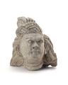 Fragmentary stucco figure showing the head of a male person with a fierce expression. The man has long hair that has been brushed back behind the ears. He is wearing a turban above which a two ends form a top-knot. For a face made using the same mould see MAS.1041 (Mi.xi.00123) and MAS.1040 (Mi.xi.00101).;