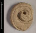 Fragment of a statue, made of yellow clay. The curled shape, here with two notched lines at the borders, is most commonly addressed as cloud ornament. Often it is part of the border of a halo. The ornament can be curled clockwise or anti-clockwise.