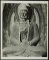 Photograph of a seated Buddha statue at Dunhuang Mogao Caves from an album presented to Raghu Vira by the Dunhuang Institute in 1955.