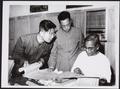 Photograph of Raghu Vira with Chang Shuhong and a colleague studying newly discovered manuscripts at the Dunhuang Institute taken in 1955.