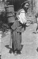 Tibetan woman carrying water.