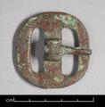 Bronze buckle of an oval shape with tongue on hinge.