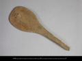 Fragment of a wooden spatula with a large and round blade end. The handle is broken.