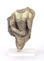 Fragmentary stucco figure. The remaining parts show the torso and arms of a female figure dressed in a clinging robe and a cloak. She is shown wearing three bangles on her right and two on her left arm. Traces of a white slip can still be seen.;
