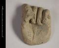 Fragment of a statue made of yellowish brown clay. Shown is a left hand with the fingers doubled down upon their lower joint, while the thumb is turned inwards over the index finger.