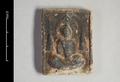 Rectangular (votive) plaque with a depiction of the Buddha. He is seated in  meditation pose on a lotus throne and before a mandorla, legs crossed and  hands held in his lap. To his left and right a small stupa is depicted. Traces of black paint are still visible.