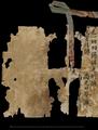 Remains of the title page of Stein Dunhuang manuscript scroll with stave and remains of silk braid.