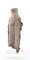 Fragmentary stucco figure of a standing male person. The legs are covered with a clinging robe, the upper body bare except for the remains of two beaded bands decorated with a rosette. The figure was made using a mould, while the jewellery was made and applied separately. Traces of a white slip can still be seen.;