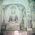 Photograph of a seated Buddha statue in Dunhuang Mogao Cave 259 taken by Raghu Vira in 1955.