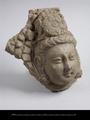 Fragment of stucco tile with Bodhisattva head.