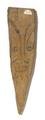 Peg made of carved wood. One side is painted with the outlines of the face of an imaginary creature.;