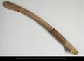 Fragmentary wooden bow. This is the upper end of a curved wooden bow with a rounded end and a carved notch which originally held the bowstring. Bark strips have been wound around the bow as a decoration