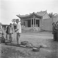 Open air theatre with fruit sellers, Gansu, China, in 1948.
