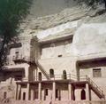 Photograph of the exterior of the Dunhuang Mogao caves taken by Raghu Vira in 1955.