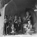 Photograph of Dunhuang Mogao Cave 458 taken by Irene Vincent in 1948 with student from the Shandan Bailie school.