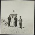 Photograph of Raghu Vira with members of the Dunhuang Institute near the Dunhuang Mogao caves taken in 1955.