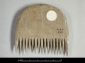 Small wooden comb with a strongly arched top. The teeth are widely spaced and very short.