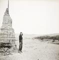 Photograph of Irene Vincent at a a stupa on the riverbank opposite Dunhuang Mogao taken in 1948.